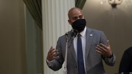 Asm. Bryan at microphone, speaking