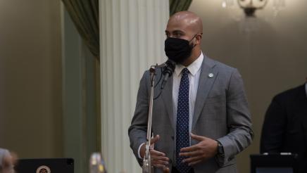 Asm. Bryan at microphone, speaking