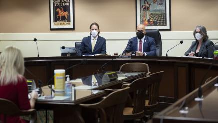 Asm. Bryan and committee members listening to woman providing testimony