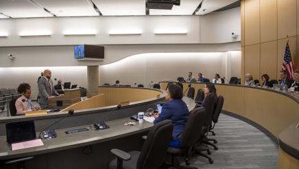 Committee members listening on as Asm. Bryan speaks