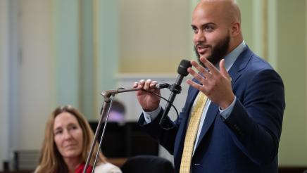 Asm. Bryan at microphone, speaking