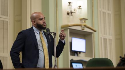 Asm. Bryan at microphone, speaking