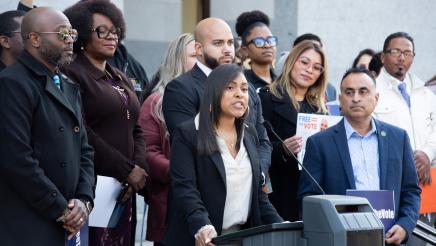 Antoinette Ratcliffe, Executive Director of Initiate Justice, at podium, speaking