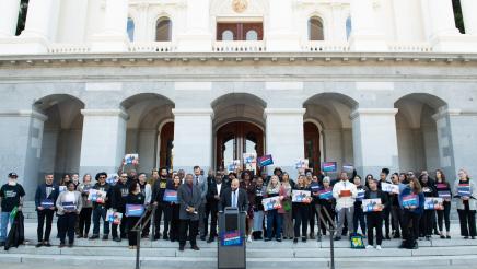 Wide view of legislators and supporters on Capitol steps