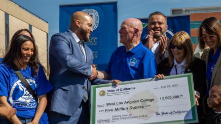 Asm. Bryan shaking hands with Center for Climate Change Education staff member
