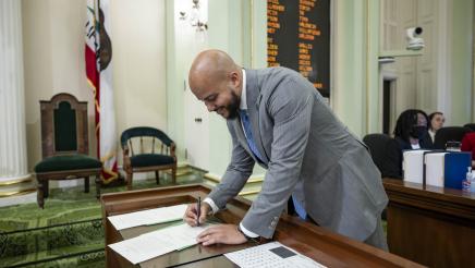Asm. Bryan signing oath documents