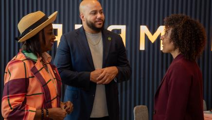 Asm. Bryan speaking with two attendees