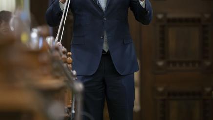 Asm. Bryan standing and speaking into microphone