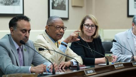 Asm. Jones Sawyer speaks while Asm. Kalra and Asm. Reyes listen on