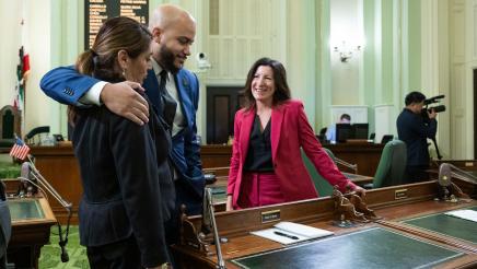 Asm. Bryan hugging a fellow assemblymember