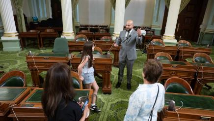Asm. Bryan speaking to guest family on the Assembly Floor