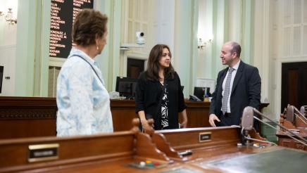 Guests conversing with staffer on the Assembly Floor