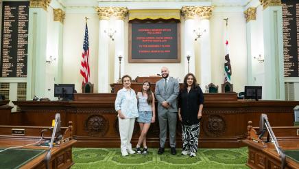 Asm. Bryan with guest family on the Assembly Floor